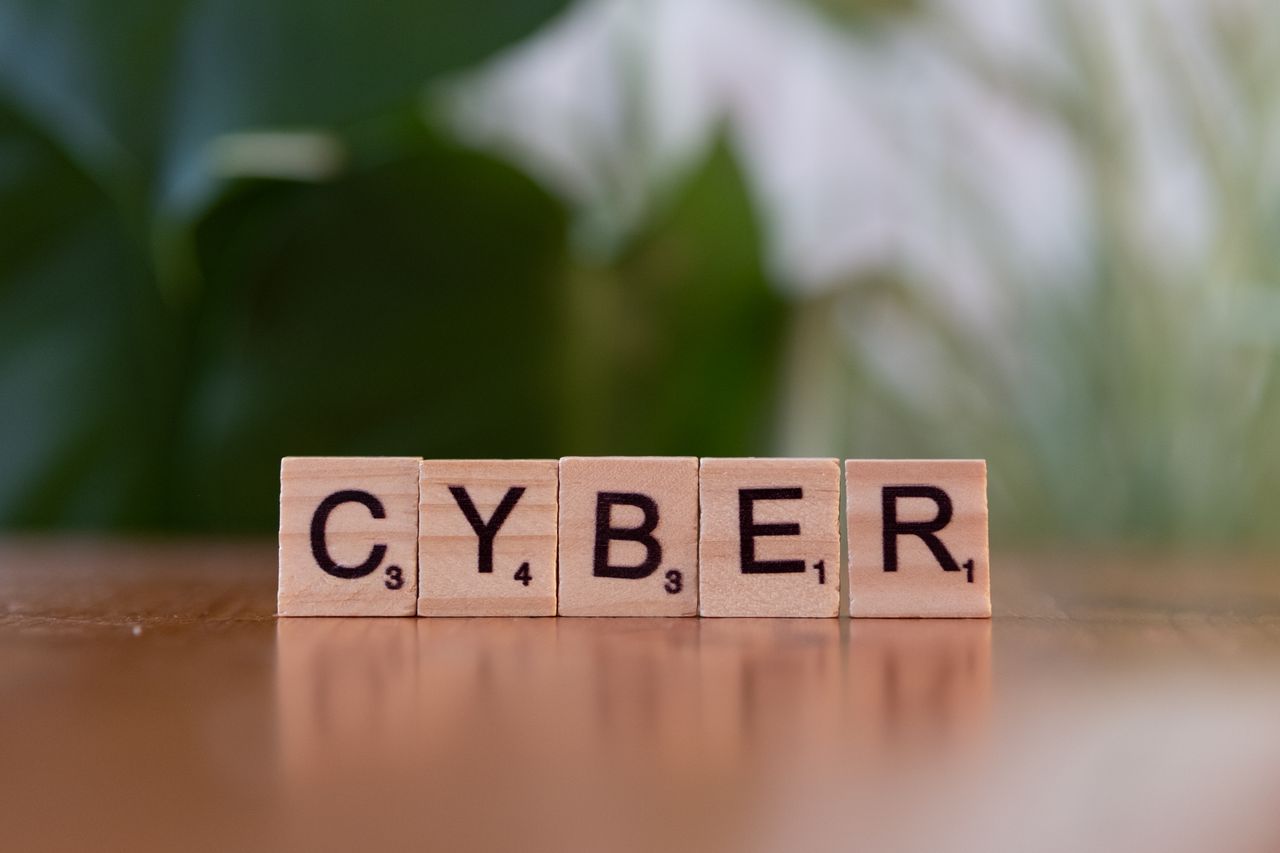 Crafting Captivating Headlines: Your awesome post title goes here Wooden letter tiles spelling 'CYBER' on a blurred background, representing cybersecurity.